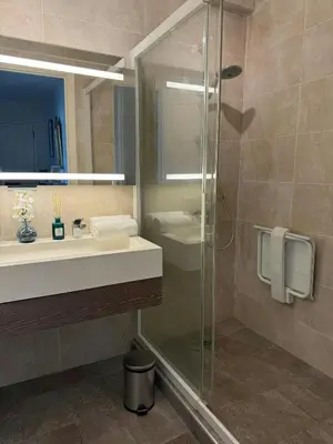 a bathroom with a sink and a glass shower at Marilyn Beach - Vue mer, terrasse, garage privé in Cannes