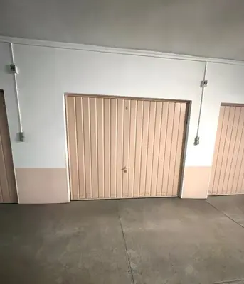 a garage with two sliding doors in a room at Marilyn Beach - Vue mer, terrasse, garage privé in Cannes