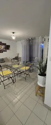 a living room with a glass table and chairs at T2 42 m2 private residence parking in Le Cannet