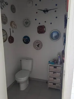 a bathroom with a toilet and plates on the wall at T2 42 m2 private residence parking in Le Cannet