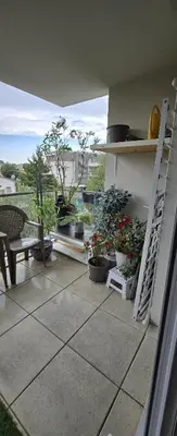 a patio with potted plants and a ladder and a bench at T2 42 m2 private residence parking in Le Cannet