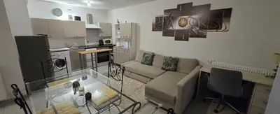 a living room with a couch and a table at T2 42 m2 private residence parking in Le Cannet