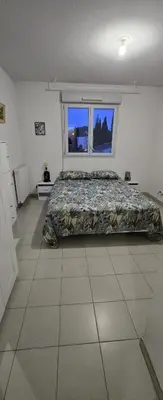 a bedroom with a bed and a window at T2 42 m2 private residence parking in Le Cannet