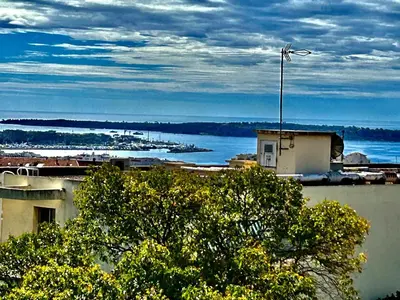 a building with a view of a body of water at Appartement rêves d'or in Cannes