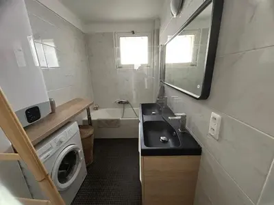 a small bathroom with a sink and a washing machine at Appartement rêves d'or in Cannes