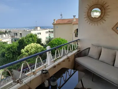 a balcony with a couch on a balcony at Appartement rêves d'or in Cannes