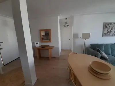 a living room with a blue couch and a table at Appartement rêves d'or in Cannes
