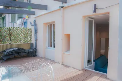 a patio with a bench next to a building at Cozy Home Cannes in Cannes