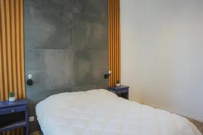 a bedroom with a white bed with two night stands at Cozy Home Cannes in Cannes