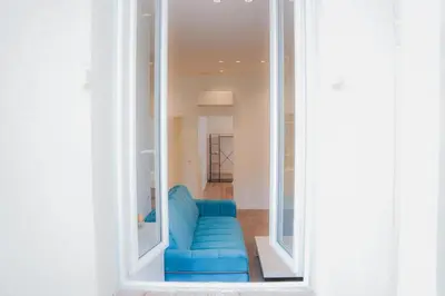 a blue couch sitting inside of a room at Cozy Home Cannes in Cannes