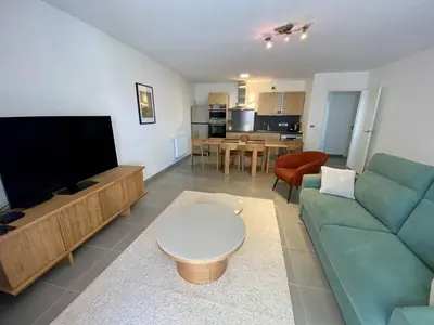a living room with a couch and a flat screen tv at Cannes proche Croisette - 3 P tout confort avec balcon in Cannes