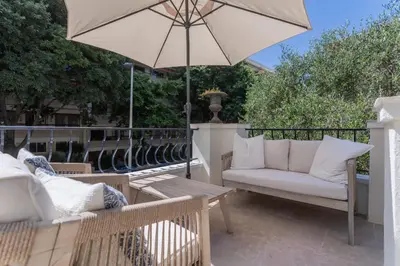 a patio with two chairs and an umbrella at REF 2177- Exceptional Villa in the Heart of Cannes 5mins from La Croisette in Cannes