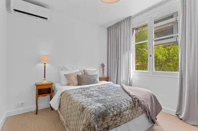 a white bedroom with a bed and a window at REF 2177- Exceptional Villa in the Heart of Cannes 5mins from La Croisette in Cannes