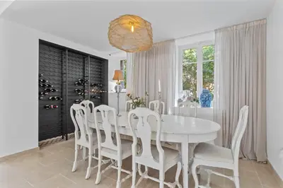 a white dining room with a white table and chairs at REF 2177- Exceptional Villa in the Heart of Cannes 5mins from La Croisette in Cannes
