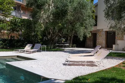 a group of lounge chairs sitting next to a pool at REF 2177- Exceptional Villa in the Heart of Cannes 5mins from La Croisette in Cannes