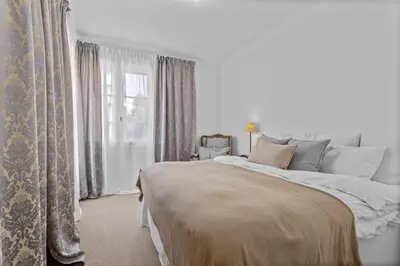 a bedroom with a large bed and a window at REF 2177- Exceptional Villa in the Heart of Cannes 5mins from La Croisette in Cannes