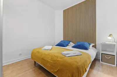 a bedroom with a bed with two blue pillows at Centre Cannes - 2 Chambres - Proche Palais - Calme in Cannes