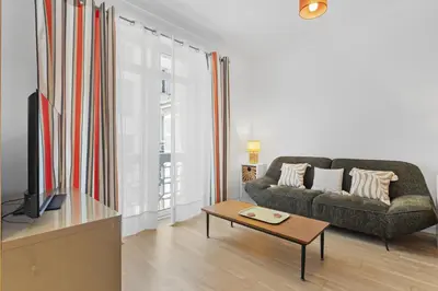 a living room with a couch and a coffee table at Centre Cannes - 2 Chambres - Proche Palais - Calme in Cannes