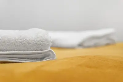 a pile of white towels sitting on top of a table at Centre Cannes - 2 Chambres - Proche Palais - Calme in Cannes