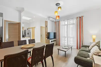 a living room with a table and a couch at Centre Cannes - 2 Chambres - Proche Palais - Calme in Cannes