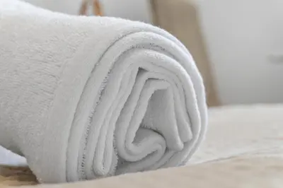 a white towel sitting on top of a bed at Centre Cannes - 1 Chambre - Proche Palais - Calme in Cannes