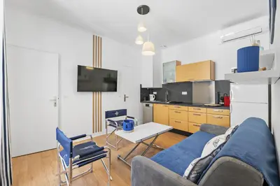 a living room with a couch and a table at Centre Cannes - 1 Chambre - Proche Palais - Calme in Cannes