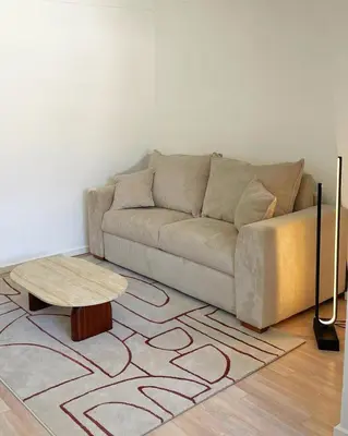 a living room with a couch and a coffee table at Chic studio Palais 2 min away in Cannes