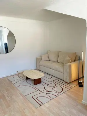 a living room with a couch and a table at Chic studio Palais 2 min away in Cannes