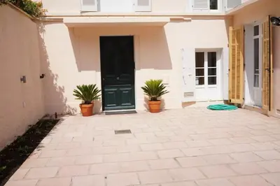 a front door of a house with two potted plants at Studio La Croisette Cannes La Croix d'Or 2 in Cannes
