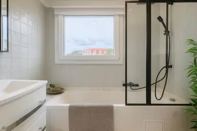 a bathroom with a shower and a tub and a sink at Apartment Center of Cannes in Cannes