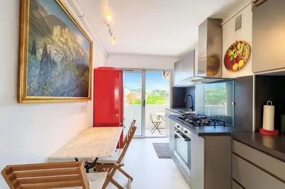 a kitchen with a table and a red refrigerator at Apartment Center of Cannes in Cannes