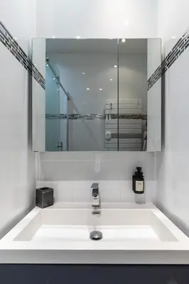 a bathroom with a sink and a mirror at Le Miramar Apartment Sea View in Cannes