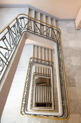 an escalator in a building with a staircase at Le Miramar Apartment Sea View in Cannes