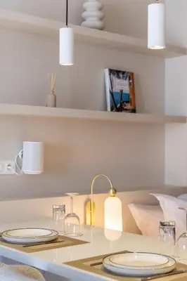 a table with plates and glasses on top of it at Le Miramar Apartment Sea View in Cannes