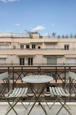 a table and chairs in front of a building at Le Miramar Apartment Sea View in Cannes