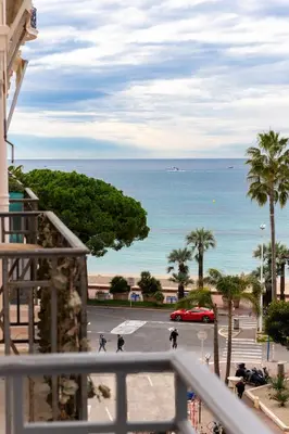a view of the ocean from the balcony of a building at Le Miramar Apartment Sea View in Cannes