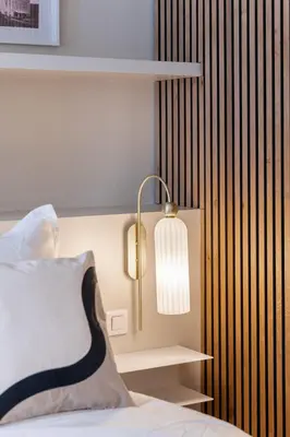 a bedroom with a bed with a lamp on it at Le Miramar Apartment Sea View in Cannes