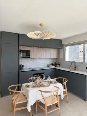 a kitchen with a table and chairs in a kitchen at Square Croisette in Cannes