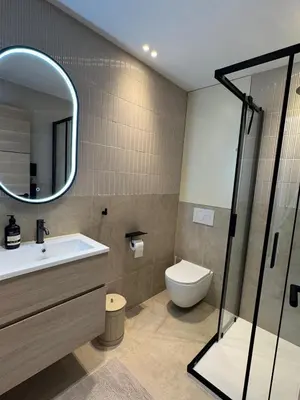 a bathroom with a sink and a toilet and a mirror at Square Croisette in Cannes