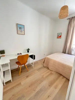 a bedroom with a desk and a bed and a desk and a chair at Appartement 4 personnes à 500 mètres des plages de sable in Cannes