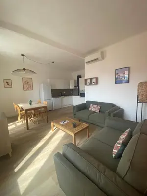 a living room with a couch and a table at Appartement 4 personnes à 500 mètres des plages de sable in Cannes