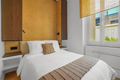 a bedroom with a white bed and a window at Élégant situé proche du palais in Cannes