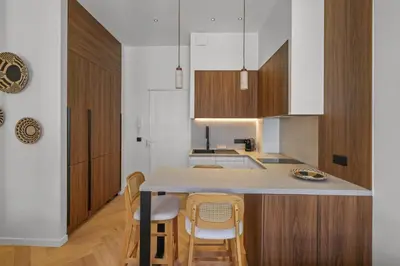 a kitchen with a table and chairs in a room at Élégant situé proche du palais in Cannes