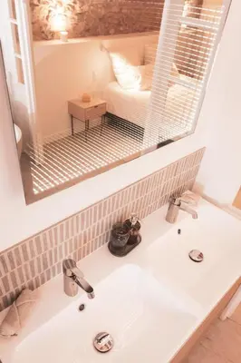 a bathroom with a sink and a mirror and a couch at Lux PH Gem 3BR 200m palais and beach in Cannes
