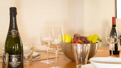 a table with wine glasses and a bowl of fruit at Lux PH Gem 3BR 200m palais and beach in Cannes