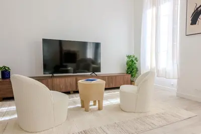 a living room with two chairs and a flat screen tv at Lux PH Gem 3BR 200m palais and beach in Cannes