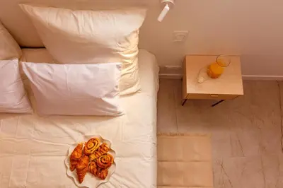 a bed with a plate of donuts on it at Lux PH Gem 3BR 200m palais and beach in Cannes
