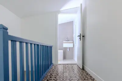 a hallway with a bathroom with a door and a tile floor at Lux PH Gem 3BR 200m palais and beach in Cannes