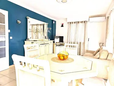 a kitchen with a table with a bowl of fruit on it at Beautiful bright apartment in Cannes