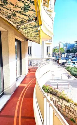 a balcony of a building with a walkway at Beautiful bright apartment in Cannes